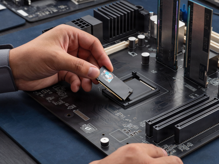 Technician installing an NVMe SSD into a computer motherboard